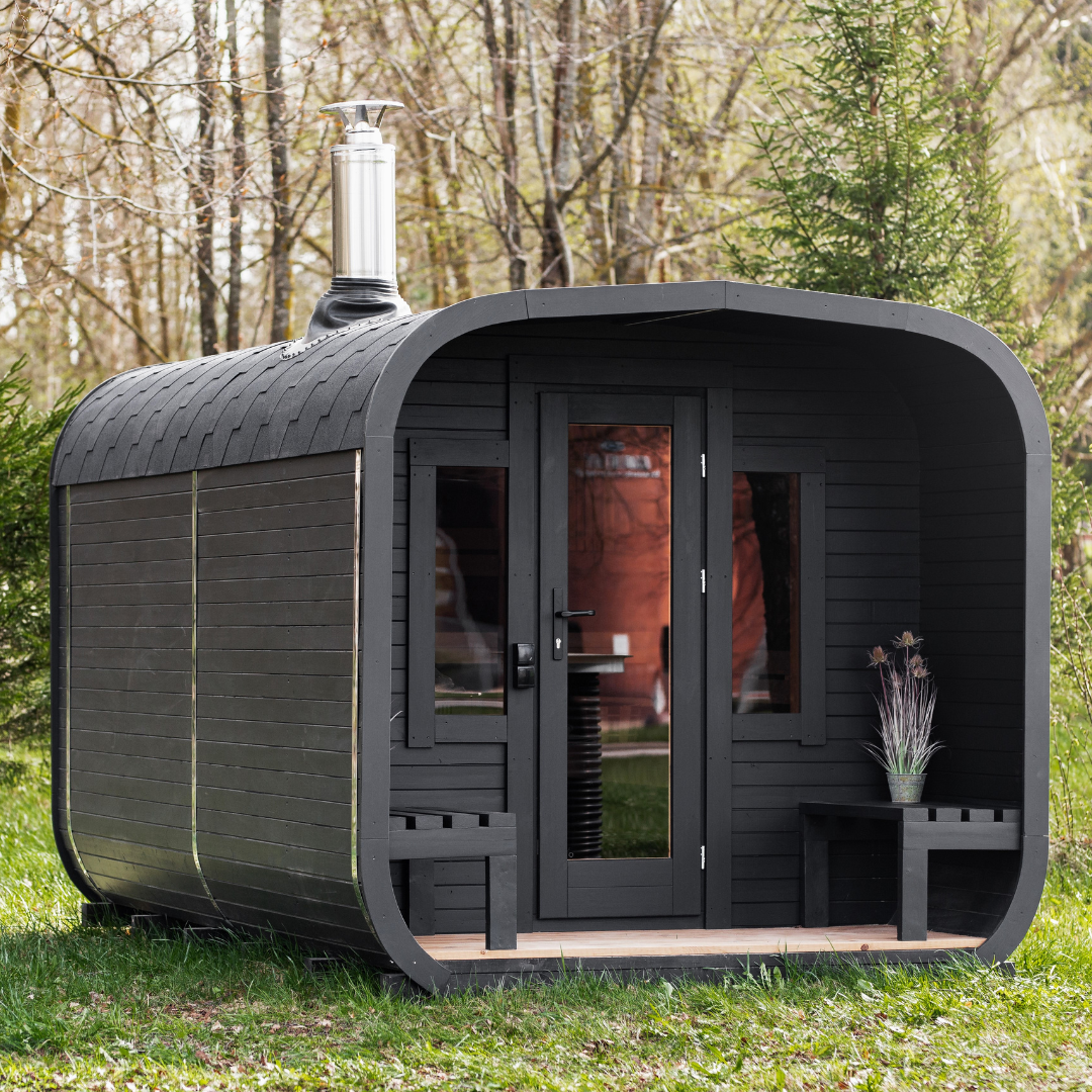 Outdoor cube sauna cabin in thermo wood set in an alpine landscape
